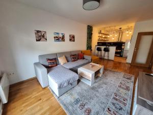 a living room with a couch and a table at Apartman Cherine in Mostar