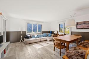 a living room with a couch and a table at Sunny Design Chalet in Engelberg with spectacular view on Mount Titlis in Engelberg