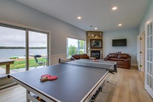 a living room with a ping pong table at Nisswa Lake Getaway with Hot Tub and Kayaks! in Nisswa