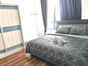 a bedroom with a bed with two dolls on it at Troika Residence Kota Bharu @ Eternity Live-1B4pax in Kota Bharu +22 photos