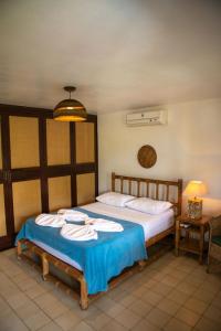 a bedroom with two beds with towels on them at Solar da Teresa in Búzios
