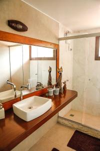 a bathroom with a sink and a mirror at Solar da Teresa in Búzios