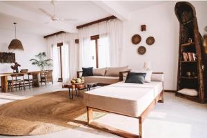 a living room with a bed and a couch at Ocean Front Villa with pool, Zanzibar in Pingwe