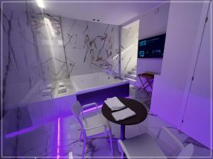 a room with purple lighting and a table and chairs at ARIOSTO HOME in Palermo