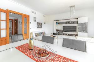 a kitchen and living room with a table and chairs at Ocean view Family Apartment in Playa La Arena in Puerto de Santiago