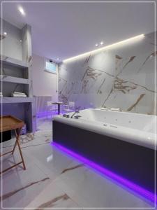 a large bathroom with a tub with purple lighting at ARIOSTO HOME in Palermo