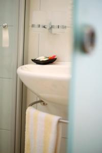 a bathroom with a white sink and a towel at Landhotel Sonnenhalde in Bad Boll