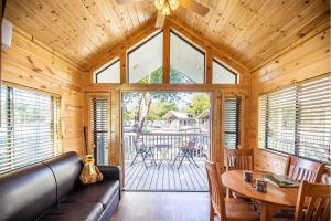 a living room with a leather couch and a table at Jellystone Park Tower Park Resort in Lodi
