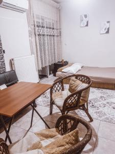 a living room with a table and chairs and a bed at ONE OF THE CHEAPEST IN THE CITY Eucalyptus in Komotini