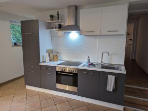 a kitchen with a sink and a stove top oven at Ferienwohnung Hofliebe in Päpinghausen in Minden