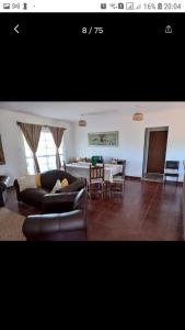 a living room with couches and a dining room at El retiro, casa de campo in San Antonio de Areco