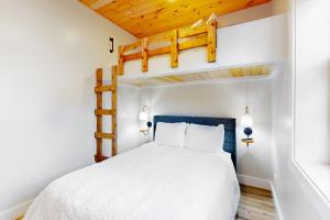 a bedroom with a bed and a loft bed at River Rock Cottage in Boone