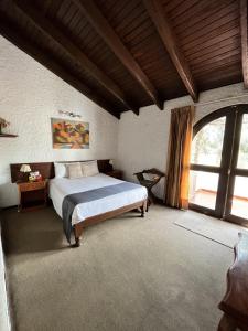 a bedroom with a bed and a large window at Hotel La Casa de Tin tin in Arequipa