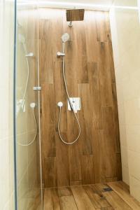 a bathroom with a shower with a glass door at City Zen in Ruse