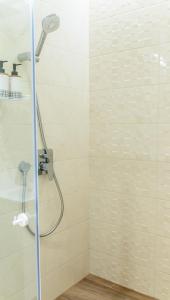 a shower with a shower head in a bathroom at City Zen in Ruse +16 photos