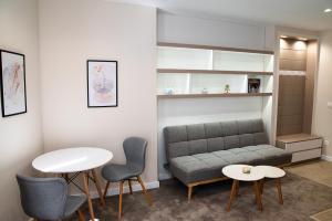 a living room with a couch and a table and chairs at City Zen in Ruse
