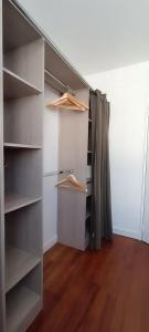 a walk in closet with wooden floors and shelves at Appartement Cosy, proche centre-ville in Quimper