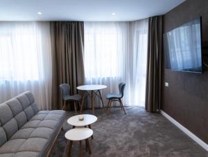 a living room with a couch and a table and chairs at City Zen in Ruse