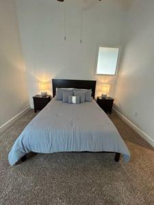 a bedroom with a large bed with two lamps at The Bentler #1 in Houston
