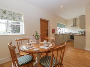 a kitchen and dining room with a table and chairs at The Pheasant Two in Usk