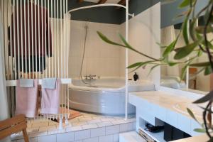 a bathroom with a tub and a toilet and a sink at La Cense - Mélin in Jodoigne +18 photos