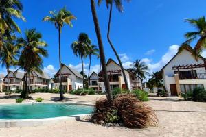 a resort with a swimming pool and palm trees at Ocean View Villa with pool, Zanzibar in Pingwe