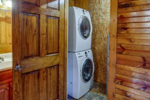 a washer and dryer in a room with a door at Secluded Cabin with On-Site Creek and Trails! 