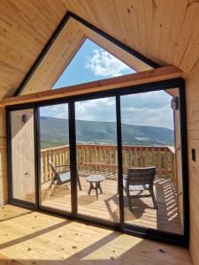 a view from the inside of a cabin with a large window at Bosques del Cielo in Los Lirios