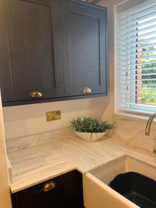 a kitchen counter with a sink and a window at 2 Bed Cottage, Houghton on the Hill, Leicestershire in Houghton on the Hill