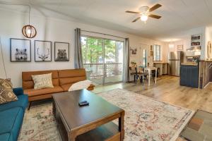 a living room with a couch and a table at Higgins Lake Cottage with Private Fire Pit and Grill! in Roscommon
