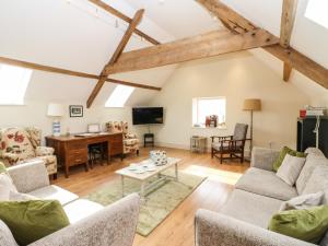 an open living room with wooden floors and beams at Cross Cottage in Durham