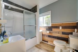 a bathroom with a toilet and a sink at Higgins Lake Cottage with Private Fire Pit and Grill! in Roscommon +19 photos