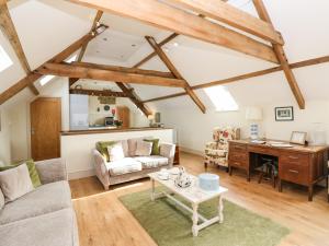 a living room with a couch and a desk at Cross Cottage in Durham