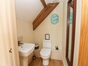 a bathroom with a white toilet and a sink at Cross Cottage in Durham +44 photos