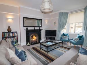 a living room with a couch and a fireplace at Fairhaven in Alnmouth