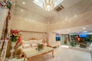 a living room with a couch and a table at Khách Sạn Cường Thanh 2 in Ho Chi Minh City