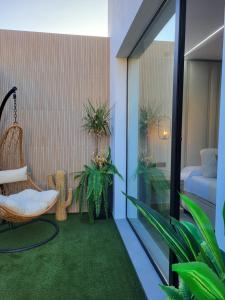 a balcony with a chair and some plants at suites home ruidera in Ruidera