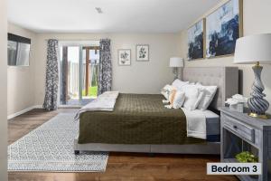 a bedroom with a bed and a door to a balcony at 3BR TH 40 Mins from DC, Pets OK, Fenced Yard in Sterling