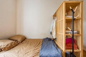 a bedroom with a wooden book shelf and a bed at ANGEL - Pleasant 1Bdr Apartment in London