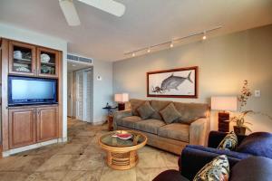 a living room with a couch and a flat screen tv at KIHEI BEACH, #506^ condo in Kihei