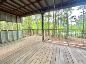 a large deck with a view of the woods at The Happy Place In The Trees in Lake Murray Shores