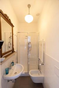 a bathroom with a shower and a sink and a mirror at Casa Giangarè in Sarzana