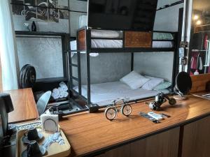 a desk with a bunk bed with a bike on it at Flat a beira mar Recife in Recife