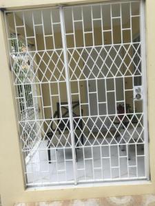 a door with a white gate in a room at Apartment in Montego Bay, St James - Fully Equipped For Long Term Stays in Montego Bay