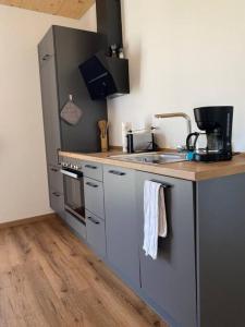 a kitchen with a sink and a counter top at Ferienwohnung Hüttenzauber in Amberg