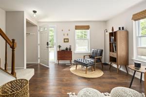 a living room with wooden floors and white walls at End Unit Townhome with in No VA, 40 Mins to DC, Pets OK in Sterling