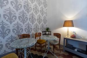 a dining room with two tables and chairs at Casa Giangarè in Sarzana