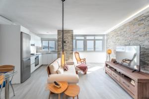 a living room with a couch and a table at Susurros del Mar Sunset in Santa Cruz de Tenerife