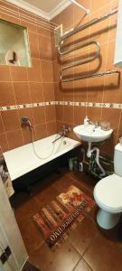 łazienka z wanną, umywalką i toaletą w obiekcie Квартира по вул Липківського 43 w Kijowie