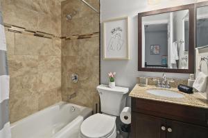 a bathroom with a tub and a toilet and a sink at Townhome in No VA, Family Community, Pet Friendly, Fast WiFi in Sterling +23 photos